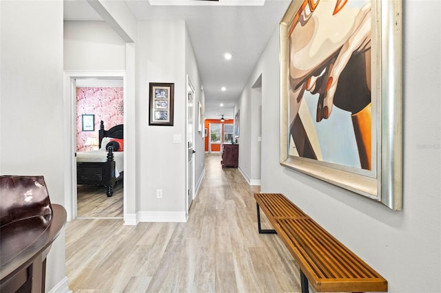 corridor with light wood-type flooring, recessed lighting, and baseboards