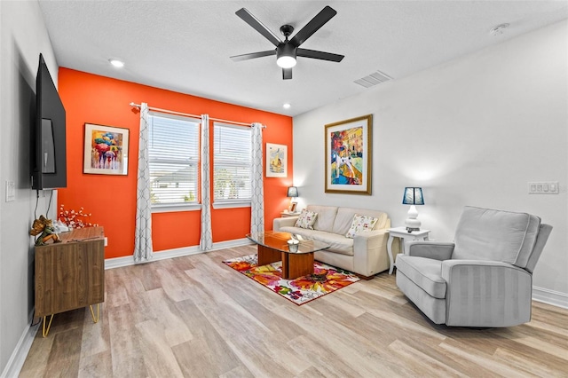 living room featuring ceiling fan, wood finished floors, and baseboards