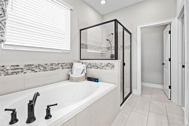 bathroom featuring a stall shower, a garden tub, tile patterned flooring, recessed lighting, and baseboards