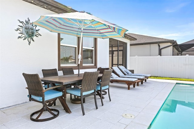 view of patio featuring fence and outdoor dining space