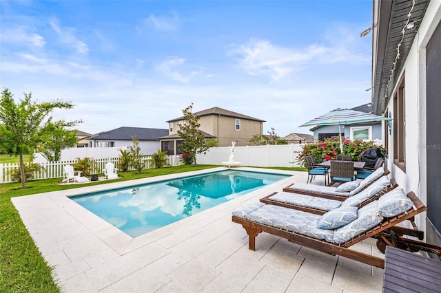 view of swimming pool featuring a patio area and a residential view