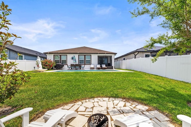 rear view of house with a patio area, outdoor lounge area, and stucco siding