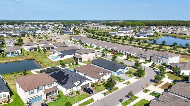 aerial view of residential area with a large body of water
