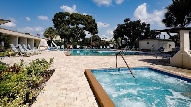 community pool with a community hot tub and a patio