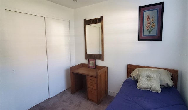 bedroom featuring light colored carpet and a closet