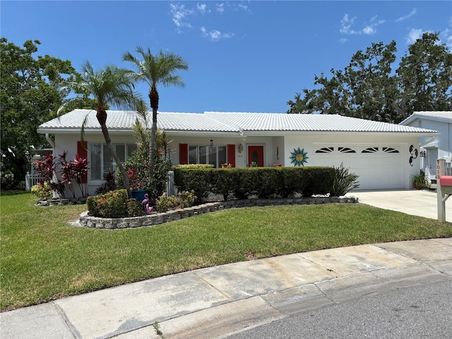 9018 39th Ln N Unit 5, Pinellas Park, FL 33782 - ranch-style house featuring a front yard, an attached garage, concrete driveway, a tiled roof, and stucco siding