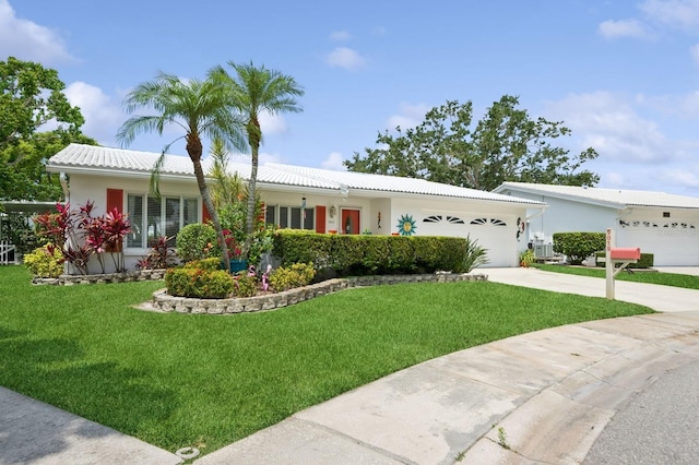 9018 39th Ln N Unit 5, Pinellas Park, FL 33782 - ranch-style home with an attached garage, a front lawn, concrete driveway, stucco siding, and a tiled roof