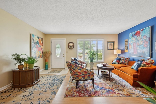 9018 39th Ln N Unit 5, Pinellas Park, FL 33782 - living room featuring a textured ceiling, wood finished floors, and baseboards