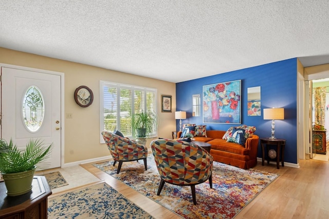 9018 39th Ln N Unit 5, Pinellas Park, FL 33782 - living room with wood finished floors, a textured ceiling, and baseboards