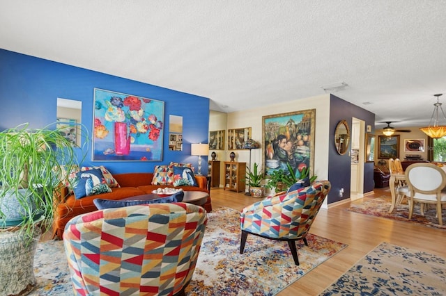 9018 39th Ln N Unit 5, Pinellas Park, FL 33782 - living area with wood finished floors, a textured ceiling, and baseboards