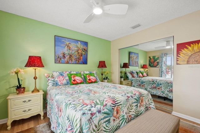 9018 39th Ln N Unit 5, Pinellas Park, FL 33782 - bedroom featuring a closet, baseboards, wood finished floors, and ceiling fan