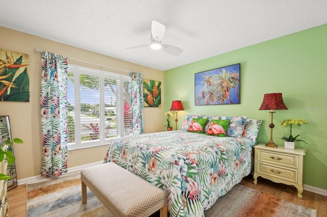 9018 39th Ln N Unit 5, Pinellas Park, FL 33782 - bedroom featuring wood finished floors, baseboards, a textured ceiling, and a ceiling fan
