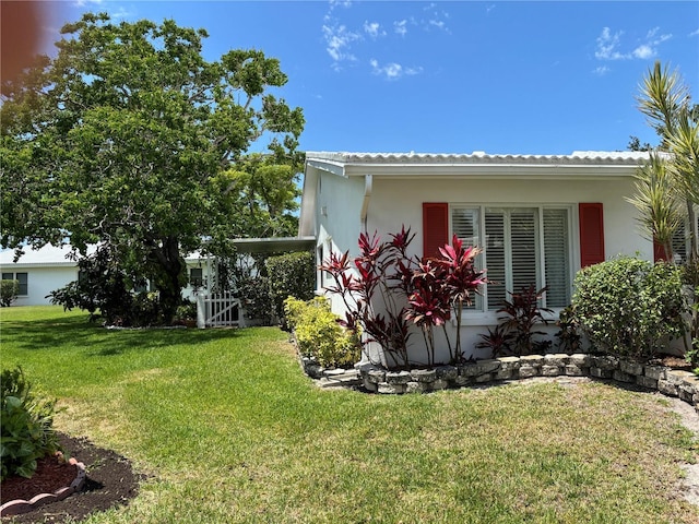 9018 39th Ln N Unit 5, Pinellas Park, FL 33782 - view of side of property with a lawn and stucco siding