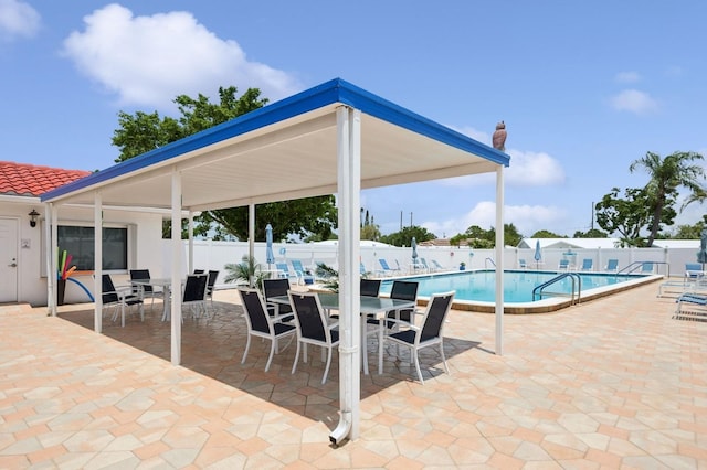 9018 39th Ln N Unit 5, Pinellas Park, FL 33782 - community pool featuring outdoor dining area, a fenced backyard, and a patio area