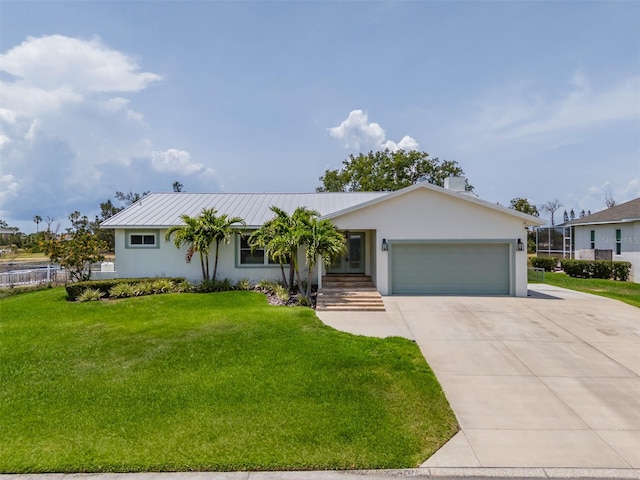ranch-style home with a garage, concrete driveway, stucco siding, metal roof, and a standing seam roof