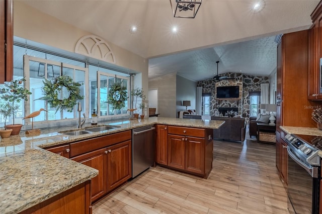 kitchen featuring dishwasher, electric stove, a sink, brown cabinetry, and a peninsula
