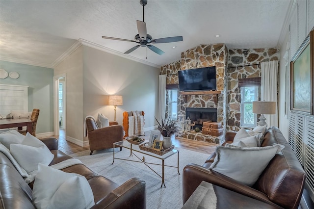 living room featuring wood finished floors, plenty of natural light, ceiling fan, baseboards, and lofted ceiling