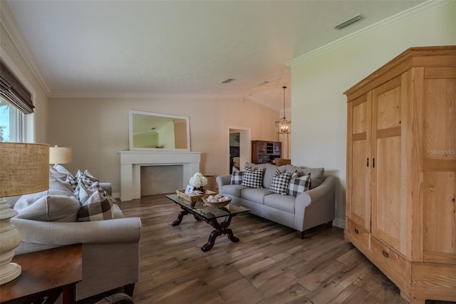 living room with a chandelier, crown molding, wood finished floors, vaulted ceiling, and baseboards