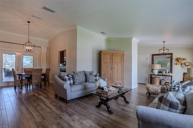 living area with dark wood-style flooring, lofted ceiling, baseboards, ornamental molding, and a chandelier