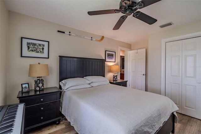 bedroom featuring light wood finished floors, a closet, and ceiling fan
