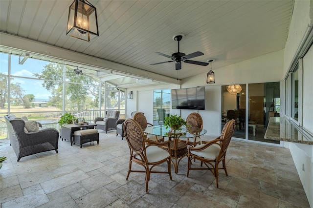 sunroom with an outdoor hangout area, ceiling fan, and lofted ceiling