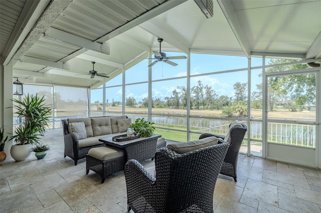 sunroom / solarium featuring ceiling fan, a water view, an outdoor living space, and plenty of natural light
