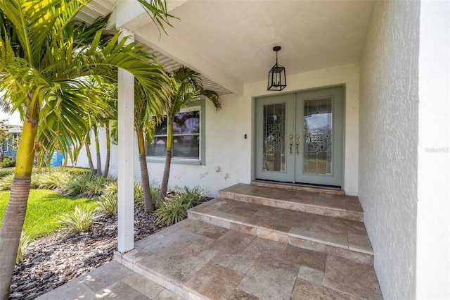entrance to property with french doors and stucco siding