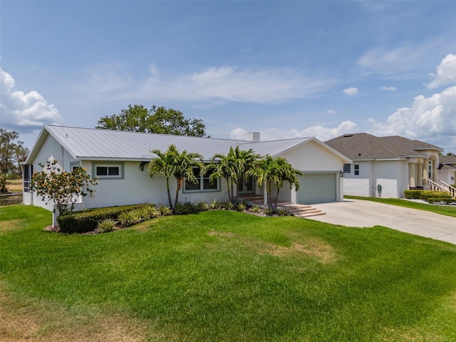ranch-style home with concrete driveway, a garage, a front yard, metal roof, and stucco siding