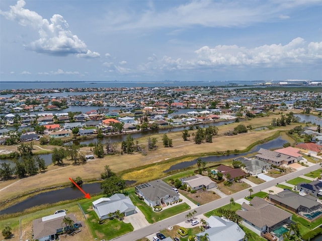 aerial overview of property's location featuring nearby suburban area and a large body of water