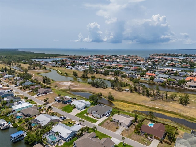 aerial view of residential area featuring a large body of water