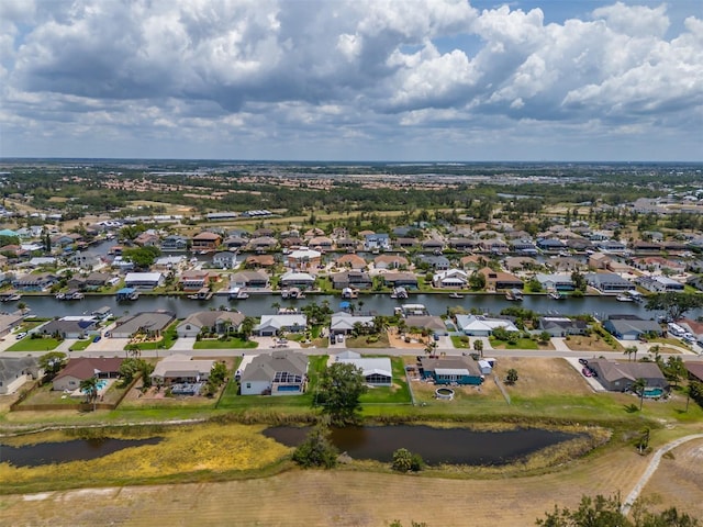 aerial view of residential area featuring a large body of water