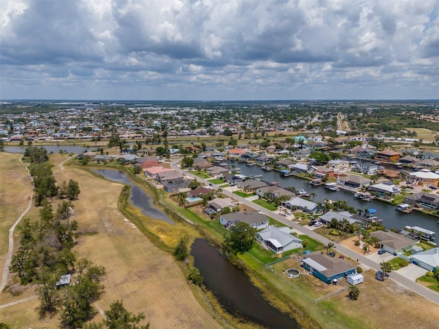 aerial view of residential area featuring a nearby body of water