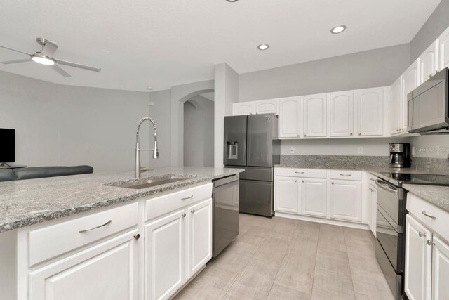 2823 Banyan Hill Ln, Land O Lakes, FL 34639 - kitchen with a sink, appliances with stainless steel finishes, arched walkways, white cabinets, and ceiling fan