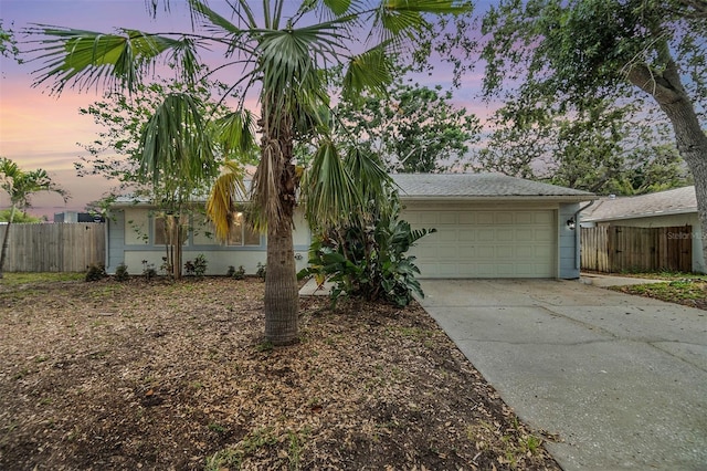 1041 Forest Grove Blvd, Palm Harbor, FL 34683 - view of front of property featuring concrete driveway, an attached garage, and fence