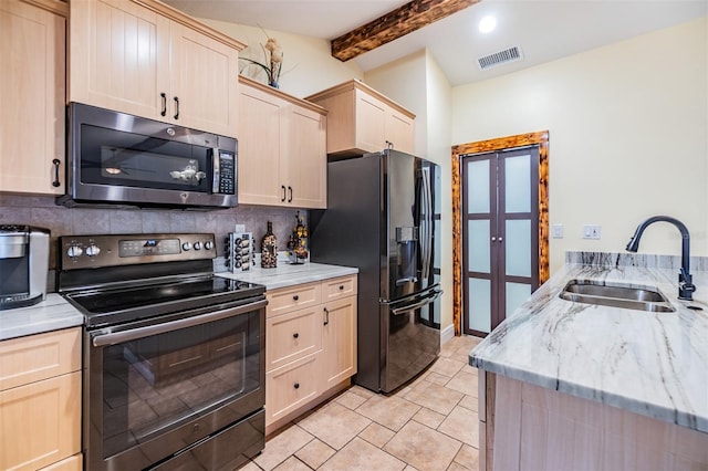 1041 Forest Grove Blvd, Palm Harbor, FL 34683 - kitchen featuring appliances with stainless steel finishes, a sink, light brown cabinetry, backsplash, and beam ceiling