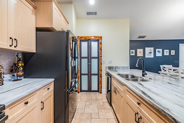 1041 Forest Grove Blvd, Palm Harbor, FL 34683 - kitchen with a sink, light brown cabinetry, freestanding refrigerator, and light stone counters