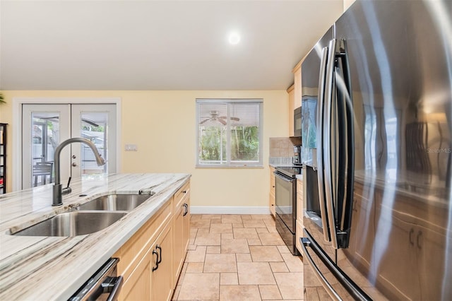 1041 Forest Grove Blvd, Palm Harbor, FL 34683 - kitchen featuring stainless steel appliances, a sink, french doors, stone tile flooring, and baseboards