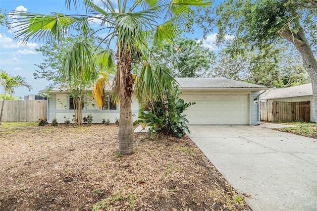 1041 Forest Grove Blvd, Palm Harbor, FL 34683 - view of front of house featuring driveway, an attached garage, fence, and stucco siding