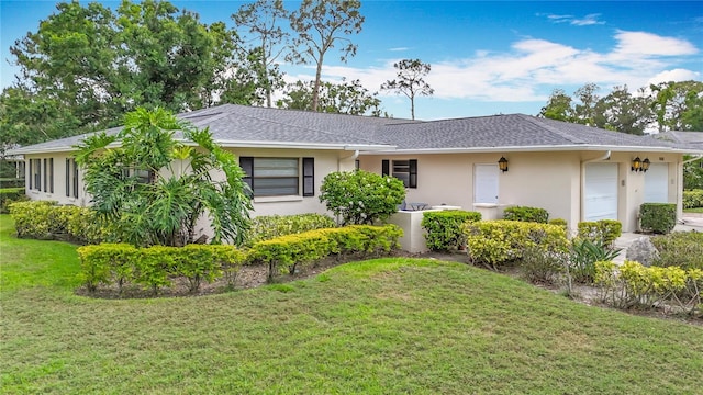 view of property exterior with an attached garage, stucco siding, a lawn, and roof with shingles
