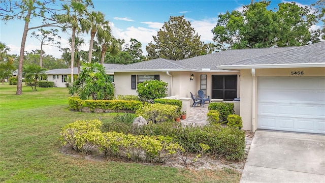 ranch-style home featuring a front yard, a garage, stucco siding, and a shingled roof