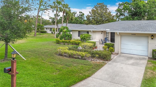 single story home featuring stucco siding, a front lawn, a garage, concrete driveway, and roof with shingles