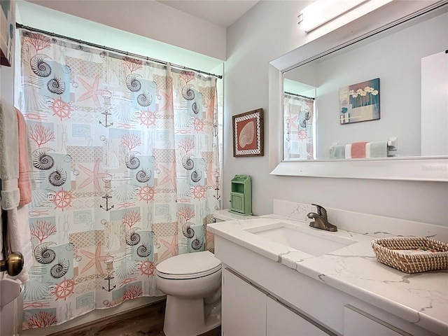 full bathroom featuring toilet, vanity, wood finished floors, and a shower with curtain
