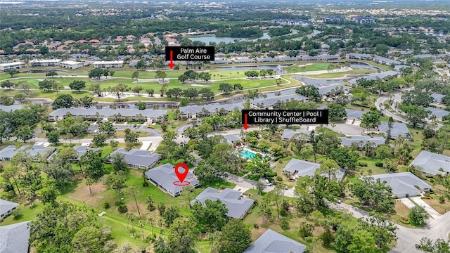 aerial view of property and surrounding area featuring a large body of water, nearby suburban area, and a golf course