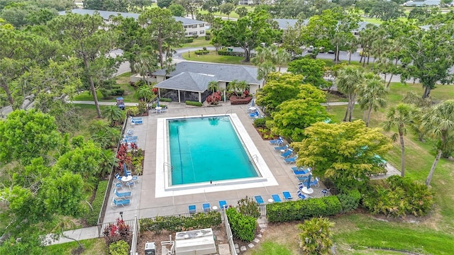 bird's eye view of a pool and a tree filled landscape