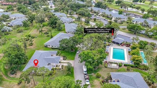 aerial overview of property's location with a pool area and nearby suburban area