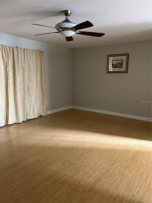 7210 N Manhattan Ave Unit 1311, Tampa, FL 33614 - spare room featuring wood finished floors, ceiling fan, and baseboards
