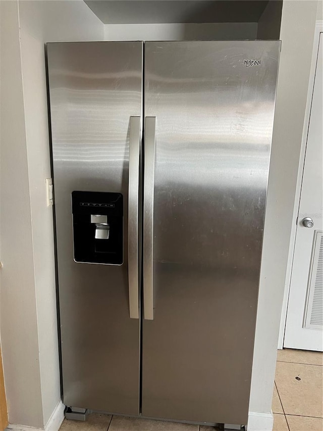 7210 N Manhattan Ave Unit 1311, Tampa, FL 33614 - kitchen view of stainless steel fridge with ice dispenser and baseboards