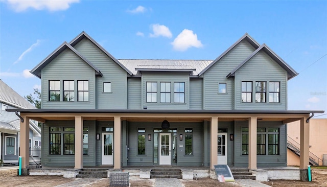 view of front facade featuring a porch and metal roof