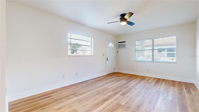 6710 S Juanita St, Tampa, FL 33616 - unfurnished room featuring light wood finished floors, a wall mounted air conditioner, baseboards, and a ceiling fan