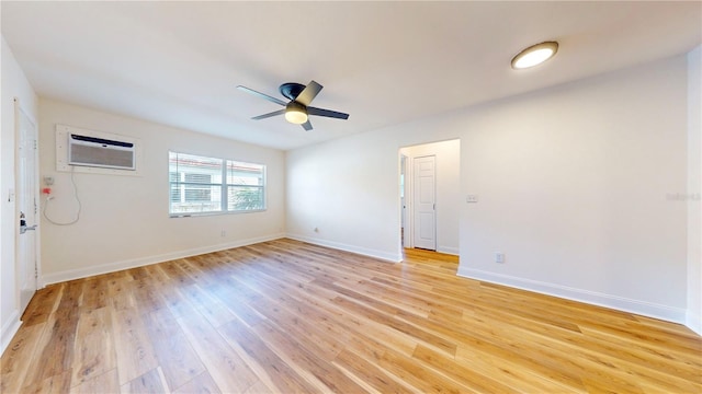 6710 S Juanita St, Tampa, FL 33616 - empty room with light wood finished floors, baseboards, a ceiling fan, and a wall mounted AC